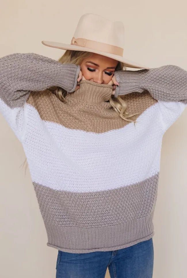 Turtleneck knit sweater with beige, white, and gray block pattern, long sleeves