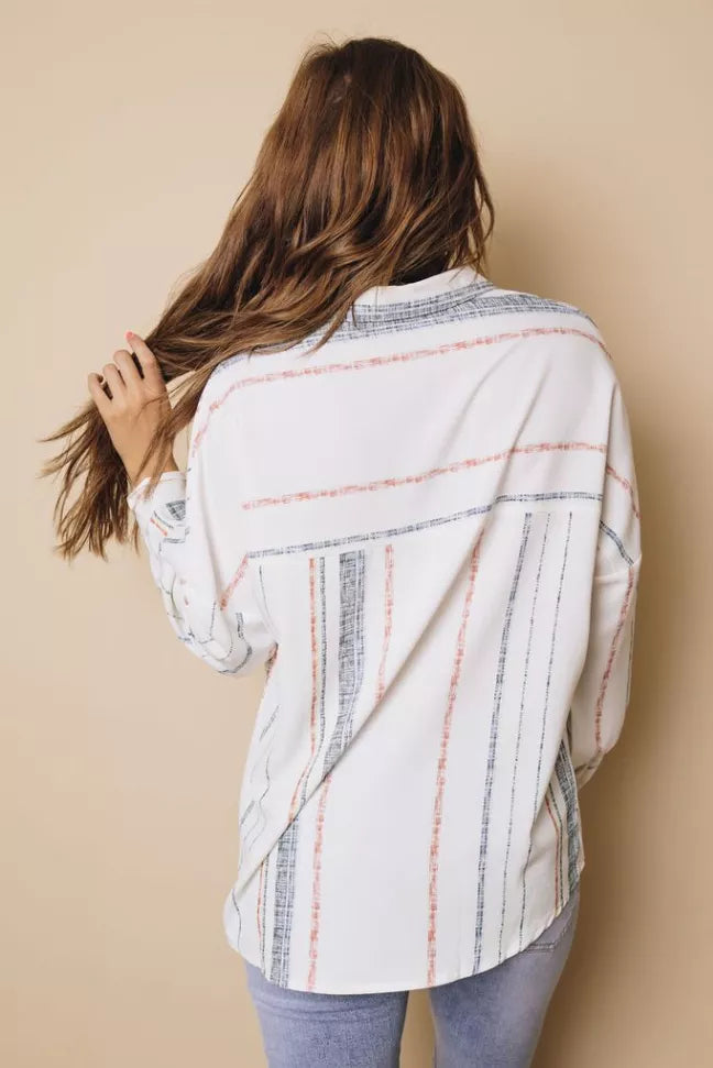 Back view of striped button-down shirt, white with blue and rust vertical lines