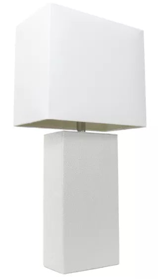 White fabric modern table lamp with geometric shade and textured white pedestal base
