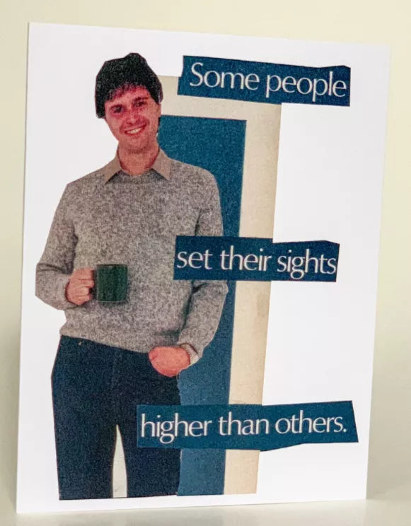 Greeting card cover with illustrated man holding mug and quote: “Some people set their sights higher than others.”