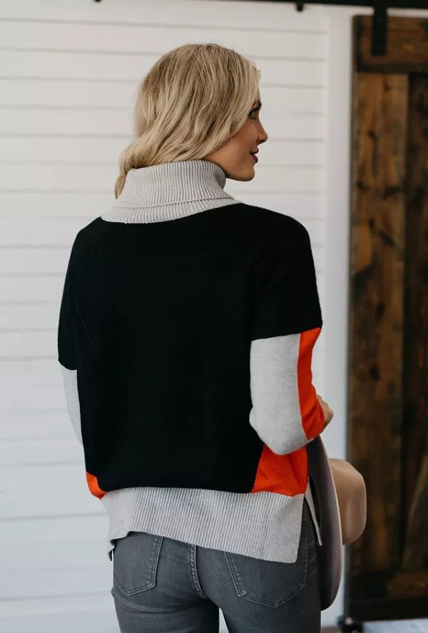 Color-block turtleneck sweater, black back with orange and gray sleeves