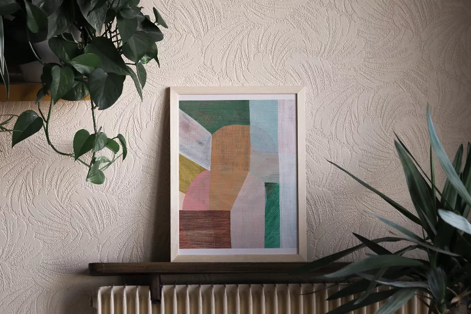 Framed abstract wall art print with geometric blue, green, orange, and pink sections