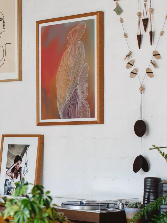 Brown-framed abstract wall print with flowing orange and purple line figures