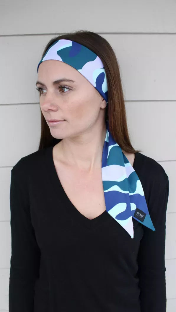 Sport headtie in navy and teal wave camo, worn with side bow on model