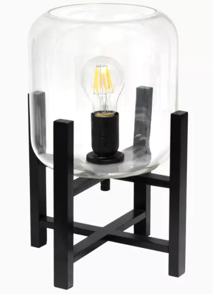 Black wood table lamp with clear cylinder glass shade and Edison bulb, open-top
