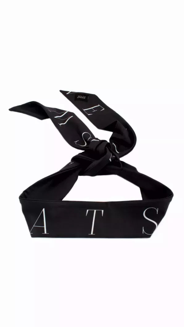 Black headtie with light geometric lettering, tied bow display