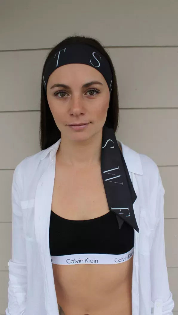 Black headtie with light geometric print, front on model with hair down
