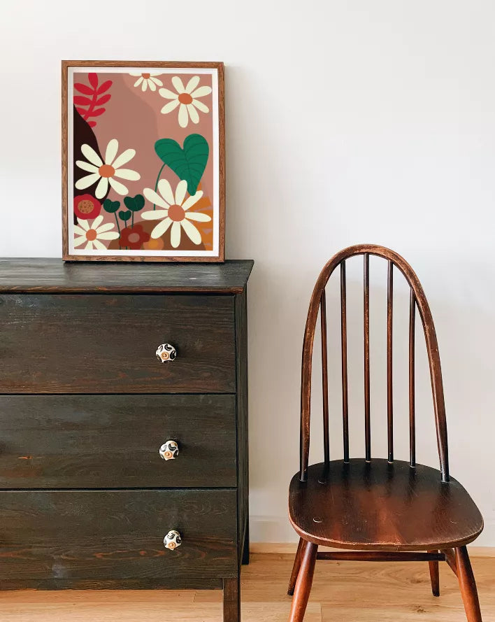 Framed floral wall art print with a wood frame, cream daisies, and green heart leaves