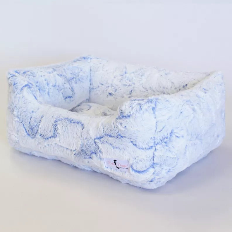 Light blue plush dog bed with padded bolsters and center cushion