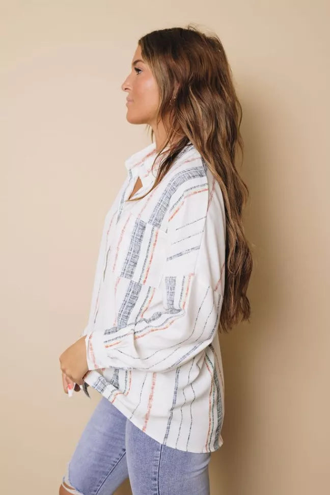 Women’s striped button-down shirt with red and blue vertical lines, side profile