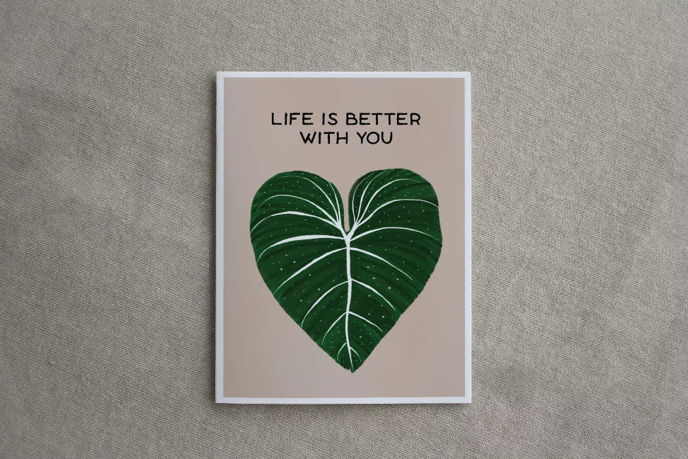 Printed greeting card with green leaf-heart and text "LIFE IS BETTER WITH YOU"