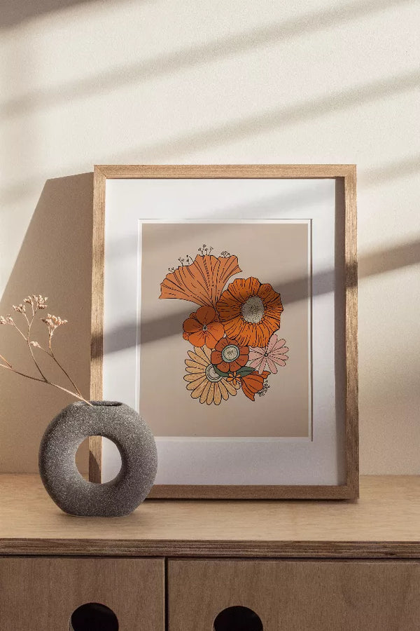 Retro floral framed print with orange and cream flower artwork in wood frame