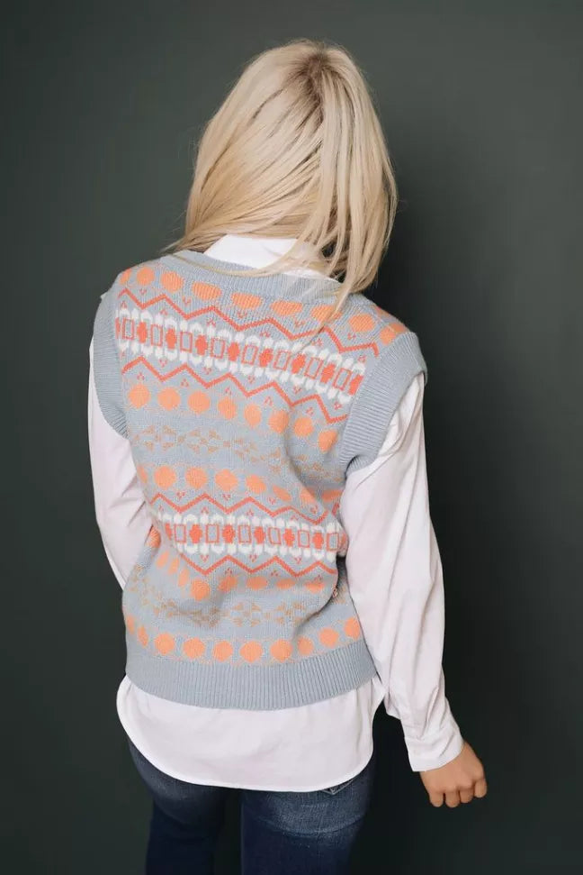 Gray knit sleeveless V-neck sweater vest with orange tribal pattern, shown from back