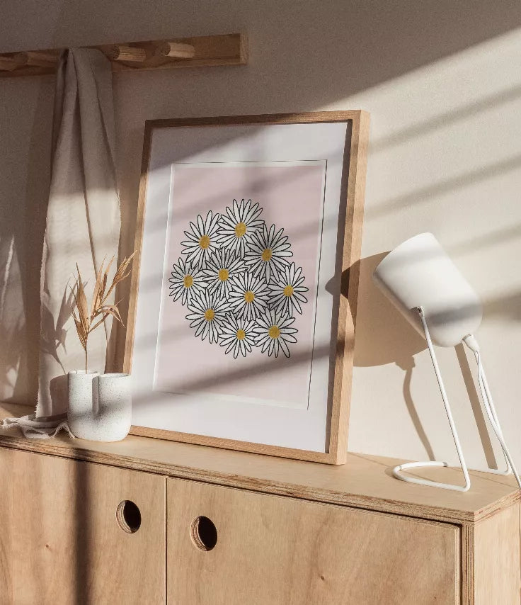 Wooden-framed daisy floral print with black line art and yellow flower centers