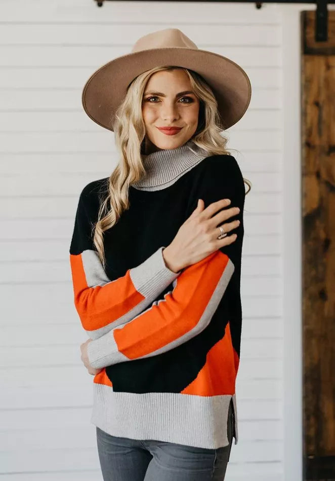Women's color-block turtleneck sweater, black with orange and gray striped sleeves