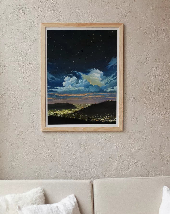 Wood-framed landscape wall art with starry night sky, clouds, dark hills, and lights