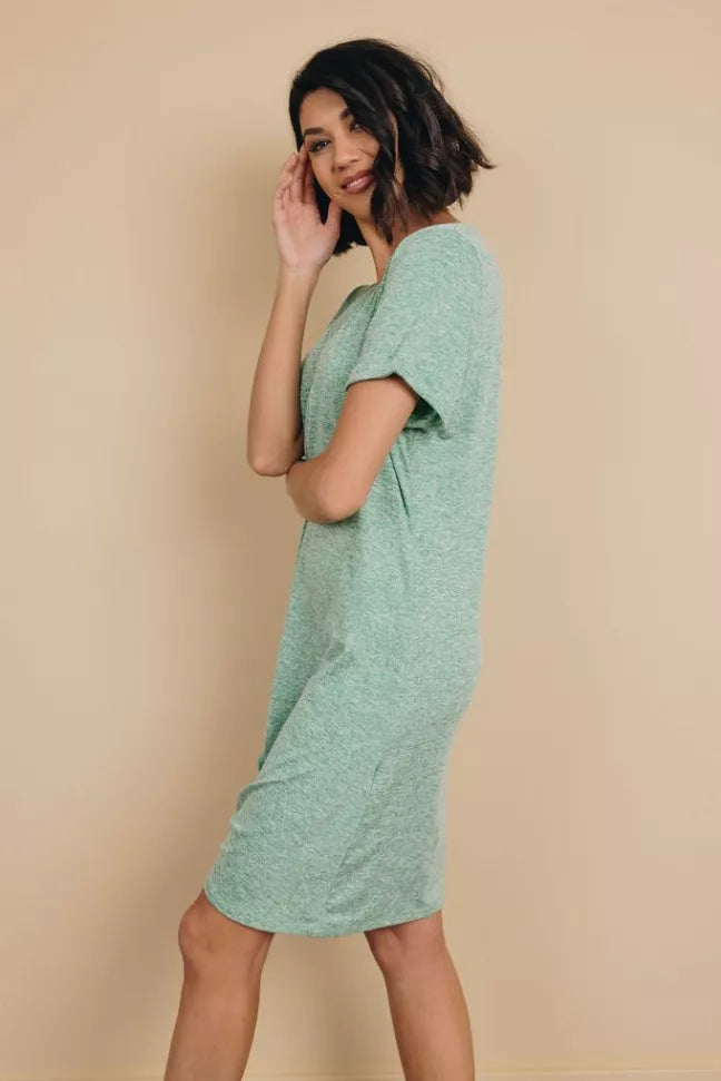 Mint green mini dress with short sleeves and draped knot at hem, angled side view.