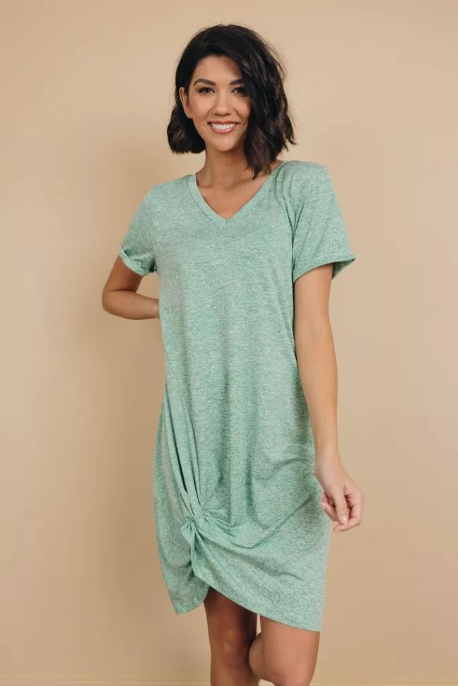 Mint green knotted mini dress with V-neck and short sleeves, knot detail at the hem.