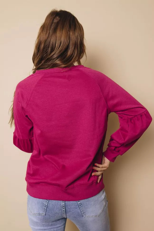 Magenta balloon-sleeve crewneck sweatshirt, back view with draped shoulders