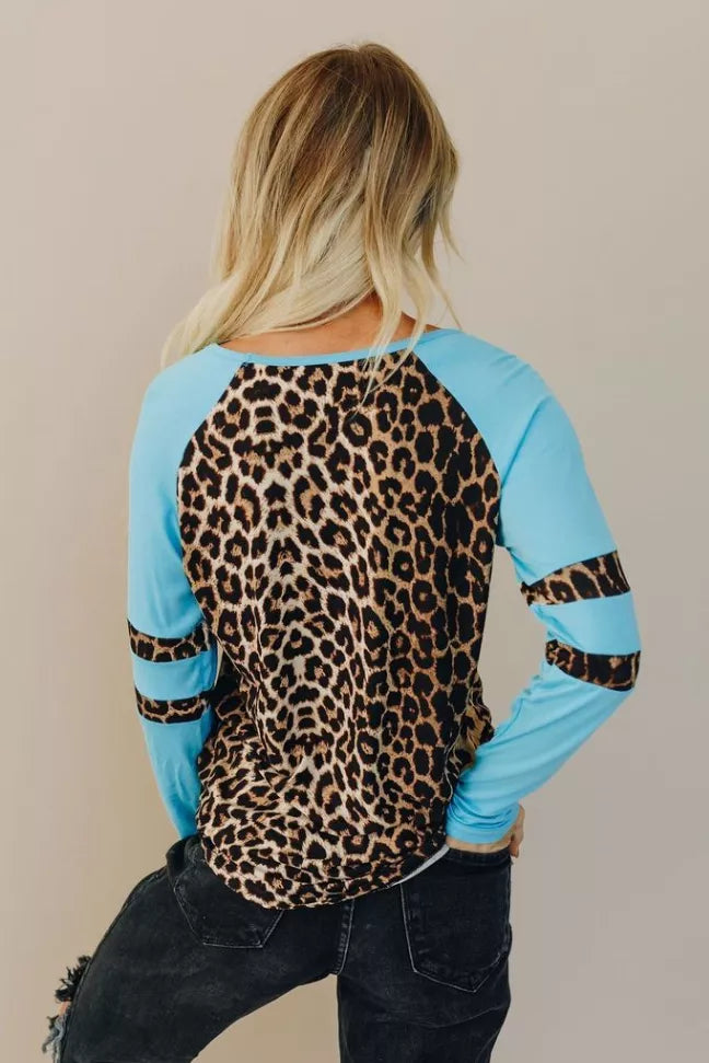 Raglan tee with leopard-print back panel and sky-blue sleeves, striped cuffs.