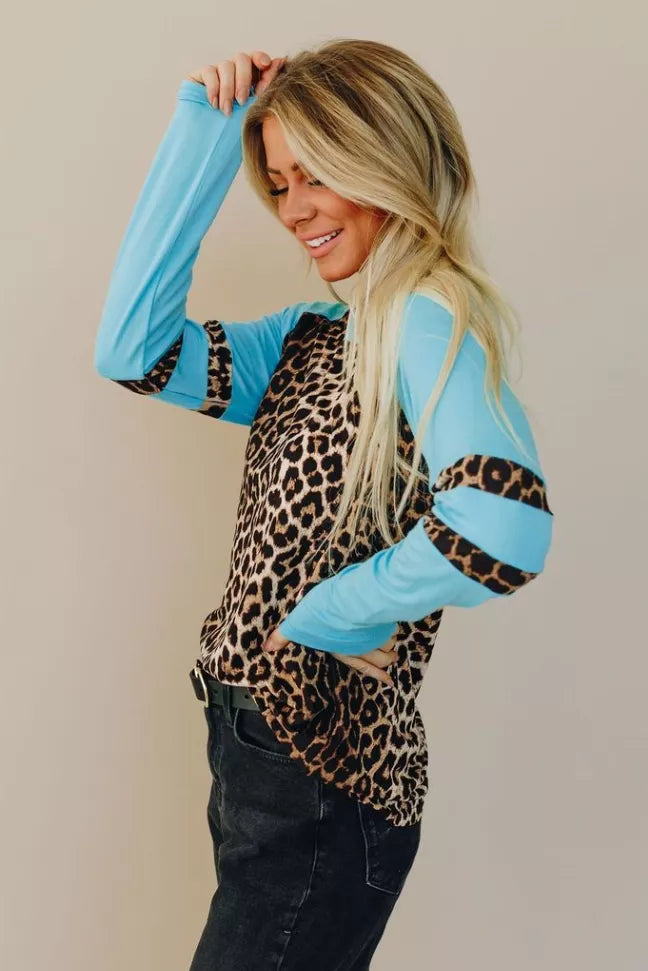 Leopard-print raglan tee with sky-blue sleeves and black cuffs, scoop neckline.