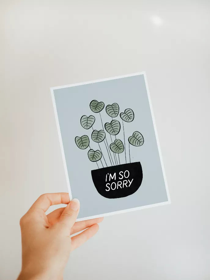 Greeting card with green leaf doodles and black circle text 'I'm so sorry'
