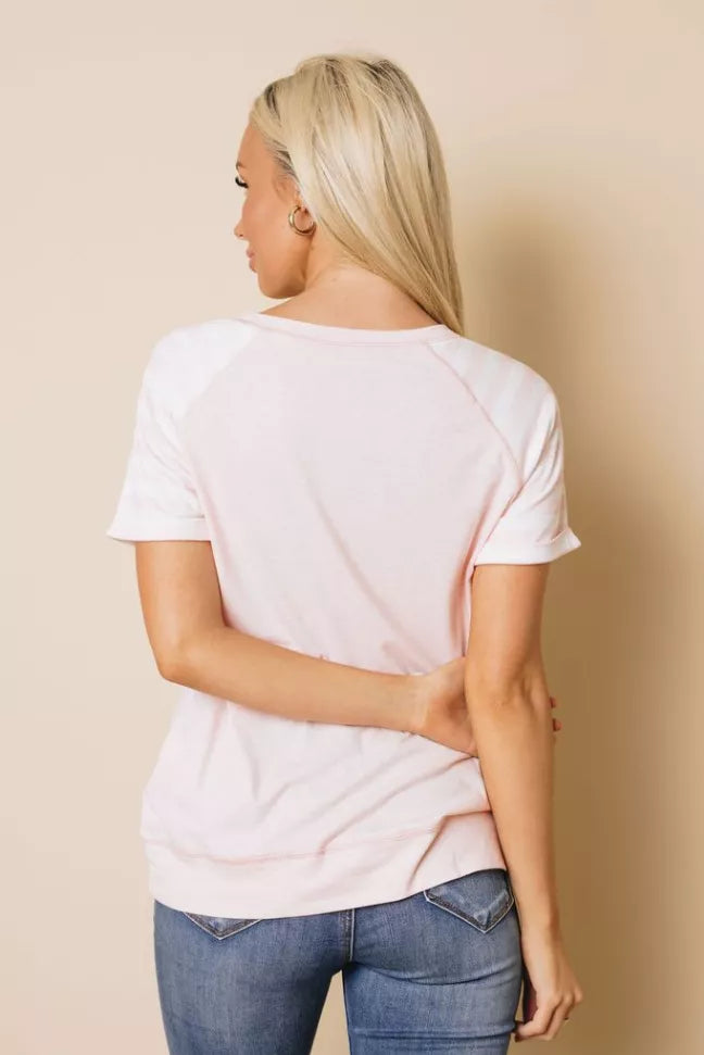 Pink short-sleeve crewneck T-shirt, back view with curved hem.