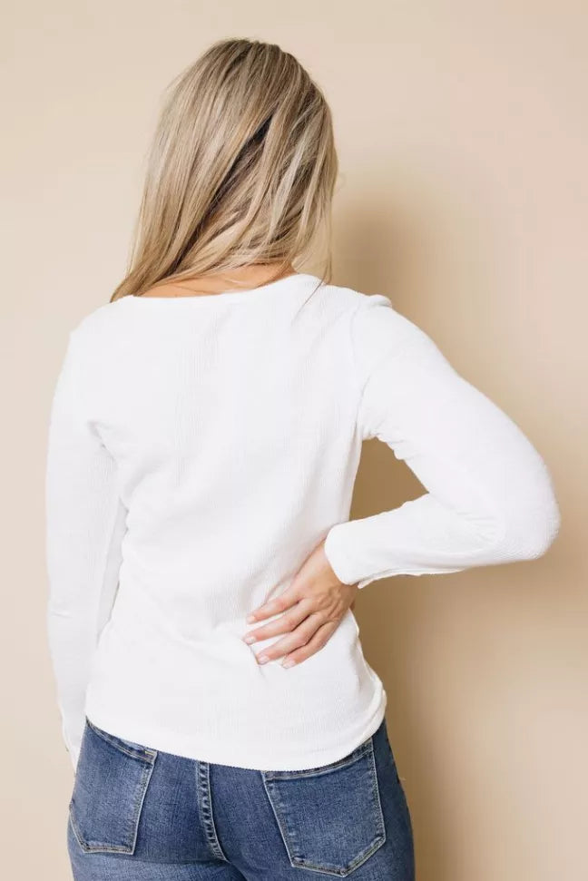 White long-sleeve henley top back view with long sleeves and rounded hem