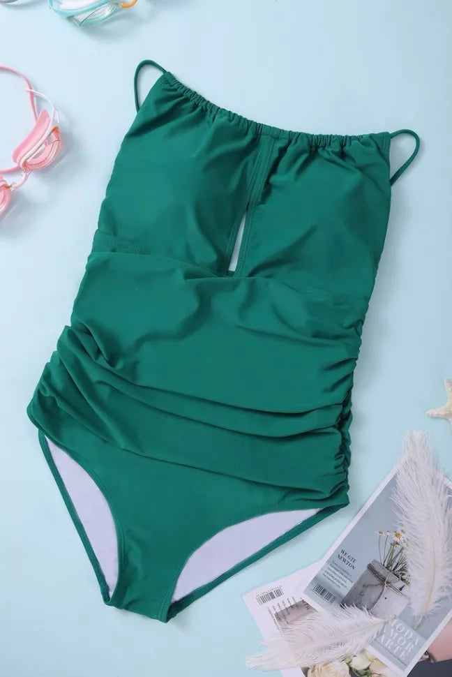 Green halter one-piece swimsuit with ruched waist and drawstring back.