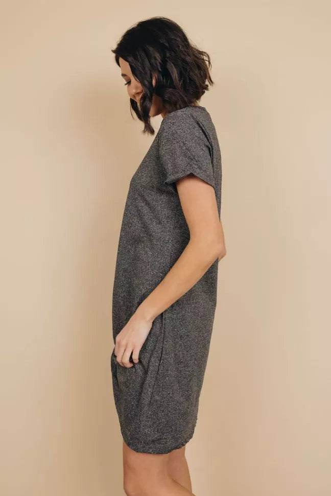 Dark gray knotted mini dress, short sleeves, side view with knotted hem