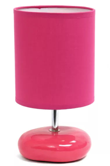 Small bedside table lamp with pink fabric shade and glossy pink base