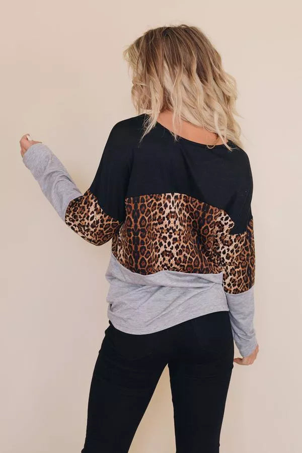 Long-sleeve leopard print top with black back, gray sleeves, and curved hem