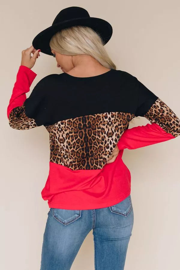 Back view: black top with leopard-print yoke and red lower sleeves