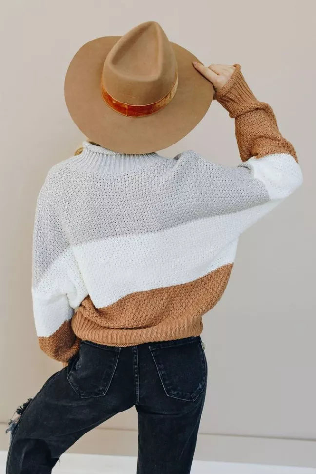 White knit turtleneck sweater with tan hem band and ribbed cuffs, back view