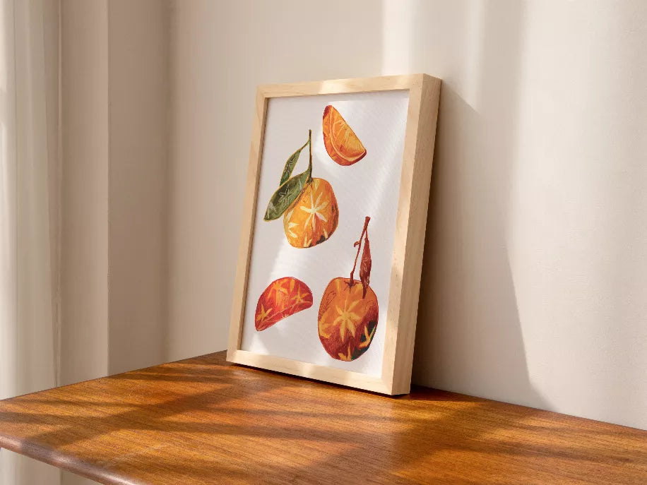 Easel-framed print of oranges and star-anise pods with slices and leaves