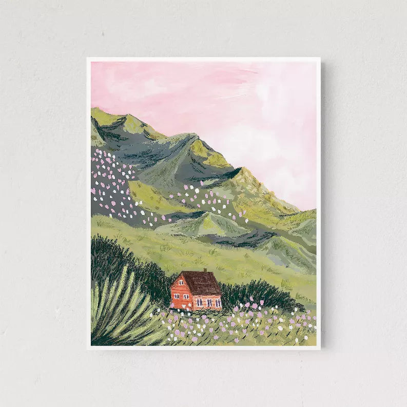Framed mountain scene wall art print with a red house in a flower meadow
