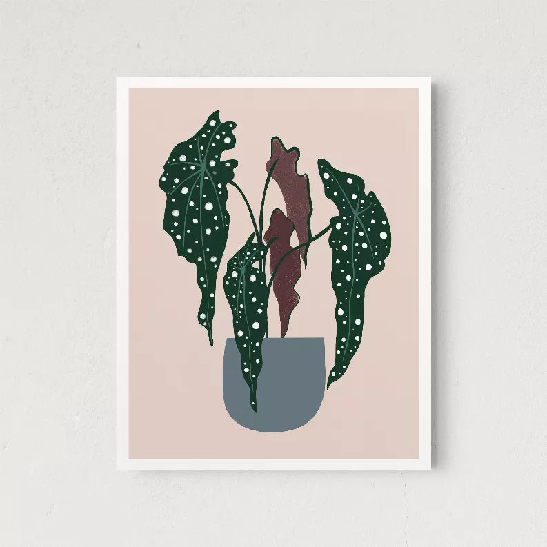 Framed plant wall art with dark green polka-dot leaves and a muted beige pot