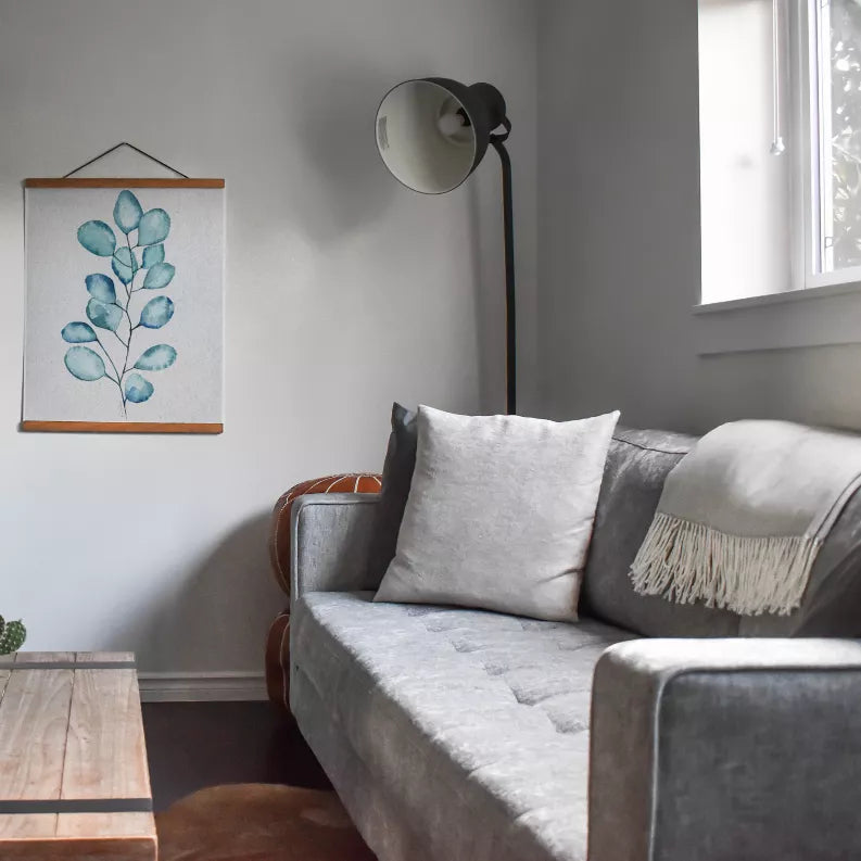 Blue eucalyptus leaves wall art print, hung in a wooden frame