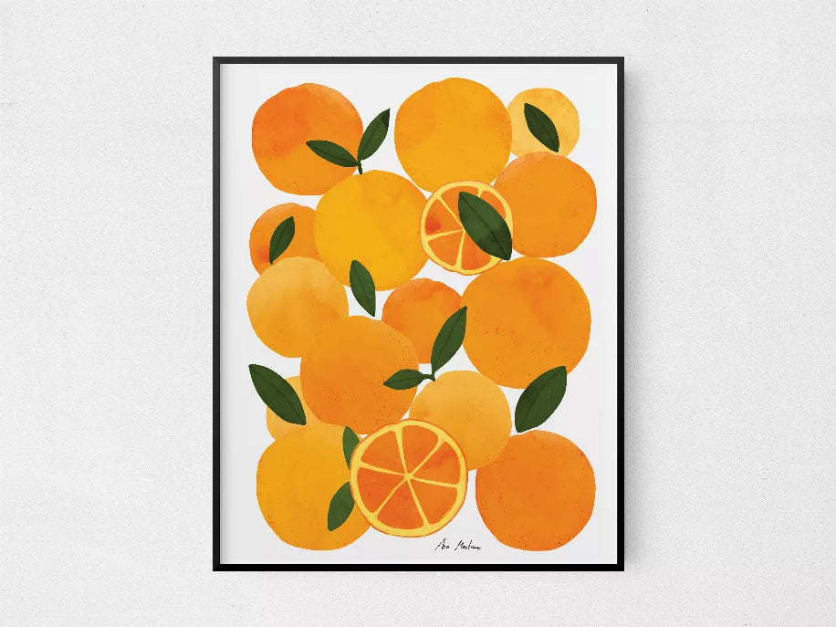 Framed square print of oranges and green leaves with citrus slice center, black border