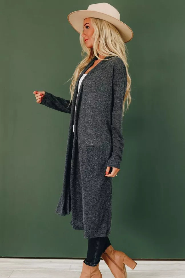 Dark heather knit cardigan with open front and long sleeves, draped hem, side view