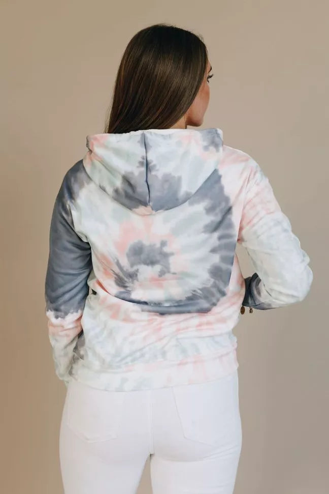 Tie-dye hoodie in white with blue and coral patterns, pullover hood and kangaroo pocket