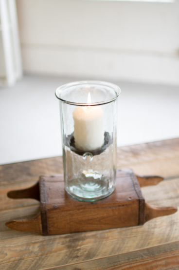 Clear mini glass candle cylinder with rustic insert, candle burning inside