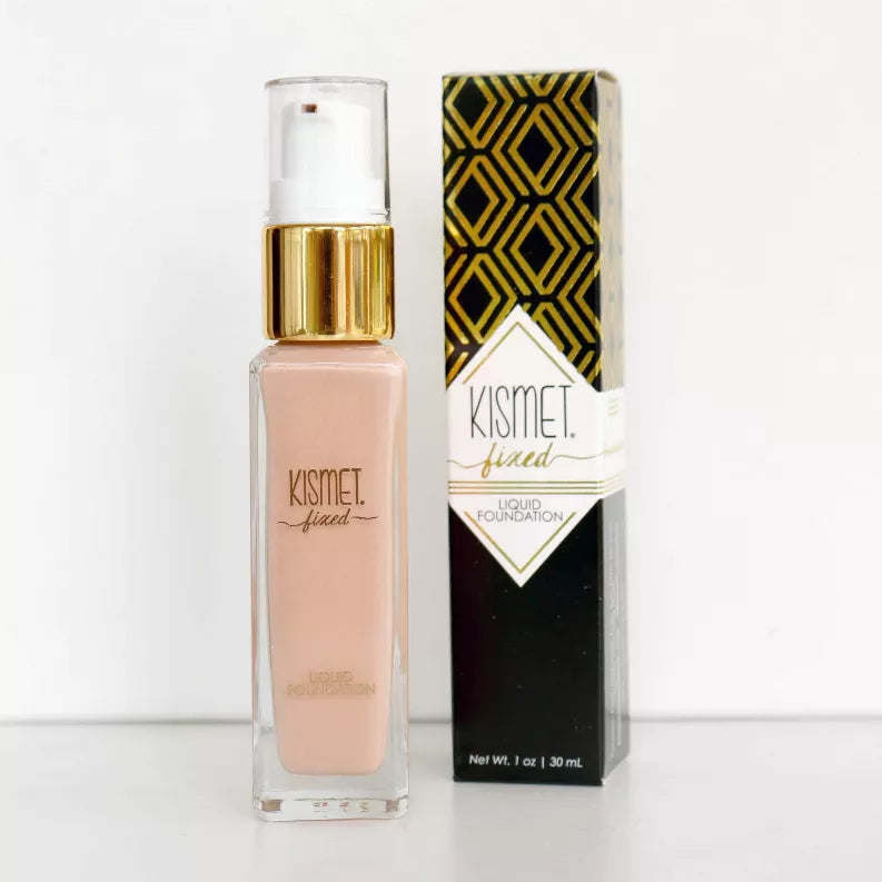 Fixed Liquid Foundation bottle with gold pump next to Kismet fixed liquid foundation box