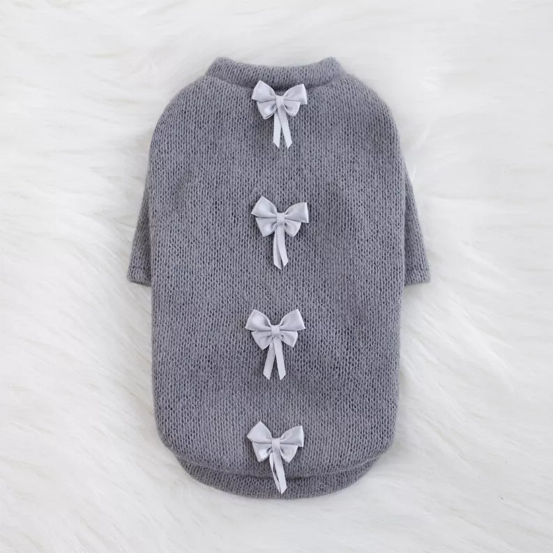 Gray knit pet sweater with four white bow appliques on the back