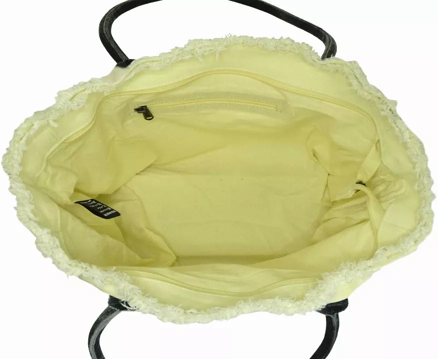 Light yellow-green tote bag with open top and visible zip pocket, black accent tag