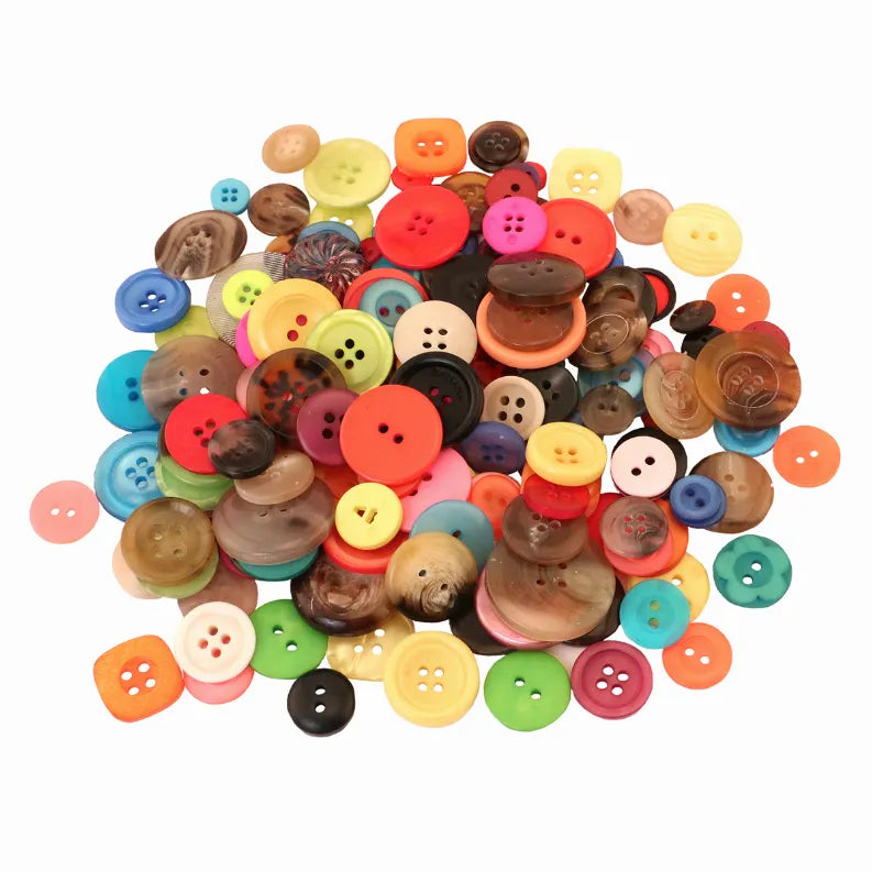 Loose pile of mixed-color round buttons with holes and embossed details