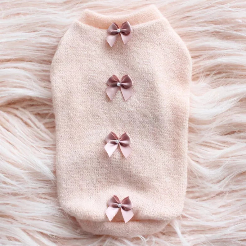 Cream fuzzy sweater with four front bows and round neckline