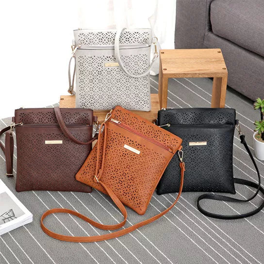 Cutout flower handbag set in brown, orange, white, and black with crossbody straps