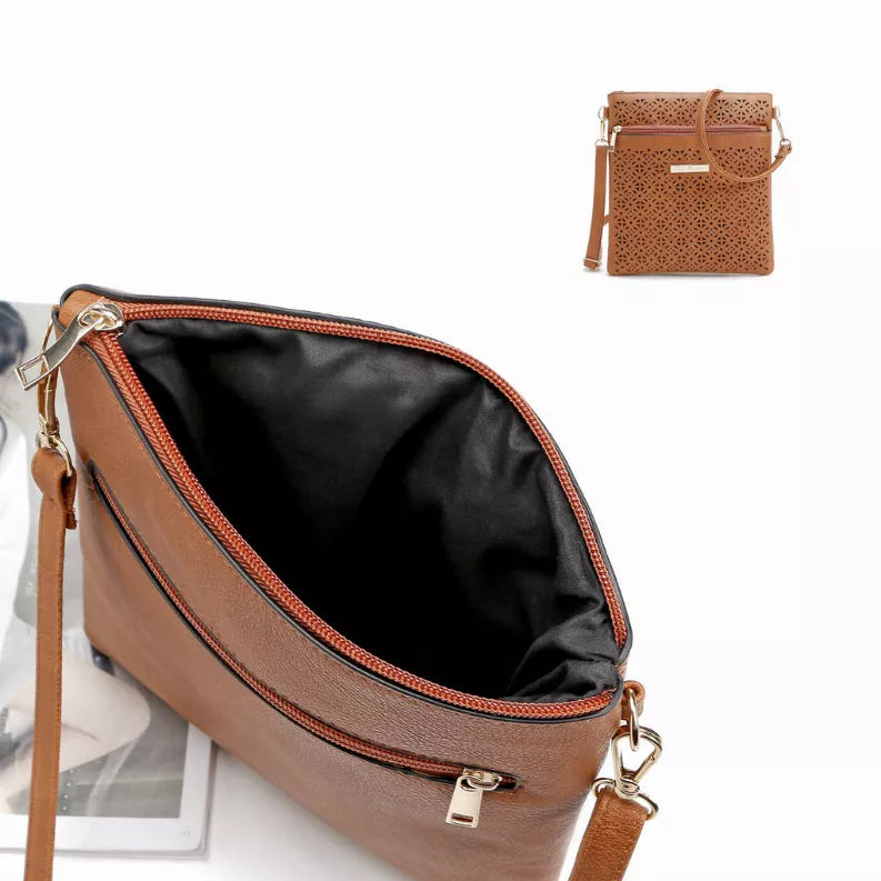 Brown cutout flower crossbody handbag with black lining and adjustable shoulder strap