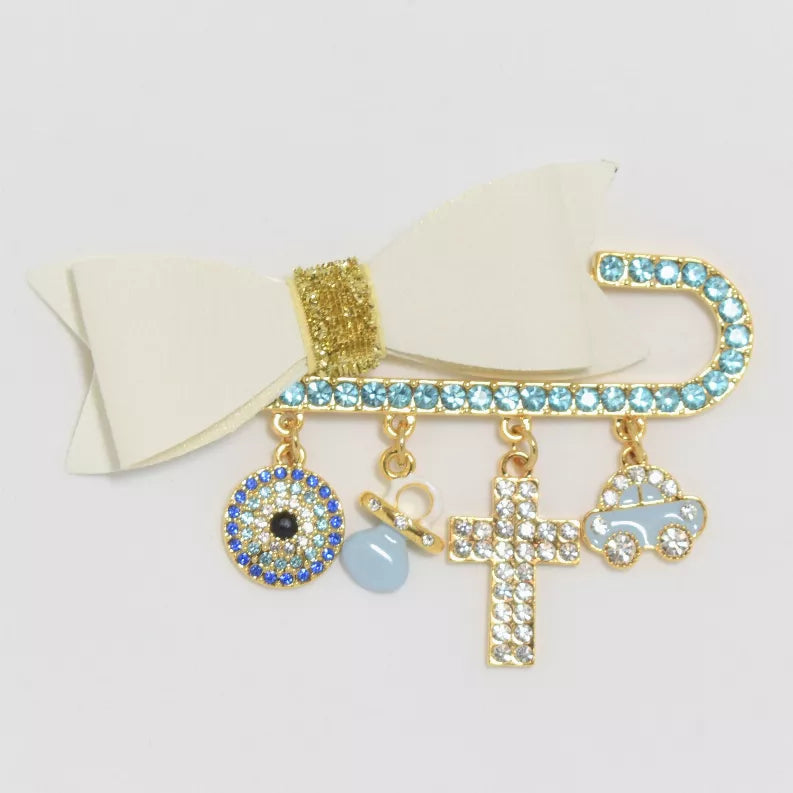 Gold-tone rhinestone baby pin with dangling charm cross, eye, pacifier and car